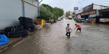 Aniden bastıran yağmur yolları göle çevirirken, bunun keyfini çocuklar çıkardı