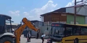 Kazı çalışması yapılan yerden geçmeye çalışan otobüs asılı kaldı