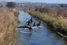 Çifte tehlike: Yangına rağmen su kanalındaki oyunlarını bozmadılar