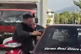 Otomobil sürücüsü dışarıya çıkmayınca motosikletli camdan içeri girmeye çalıştı